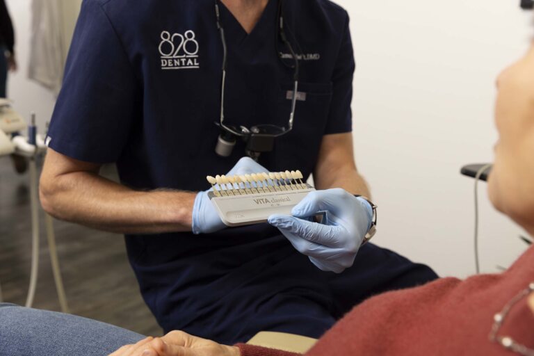 Asheville dentist showing porcelain crown colors to a patient