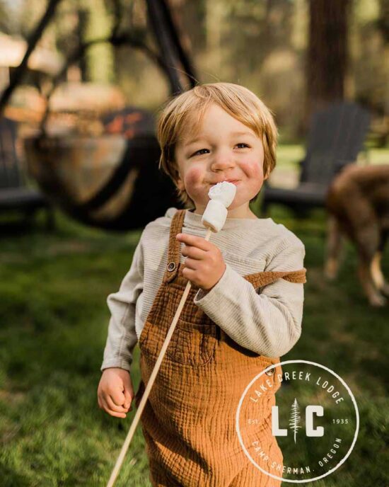 Happy child eating a marshmallow