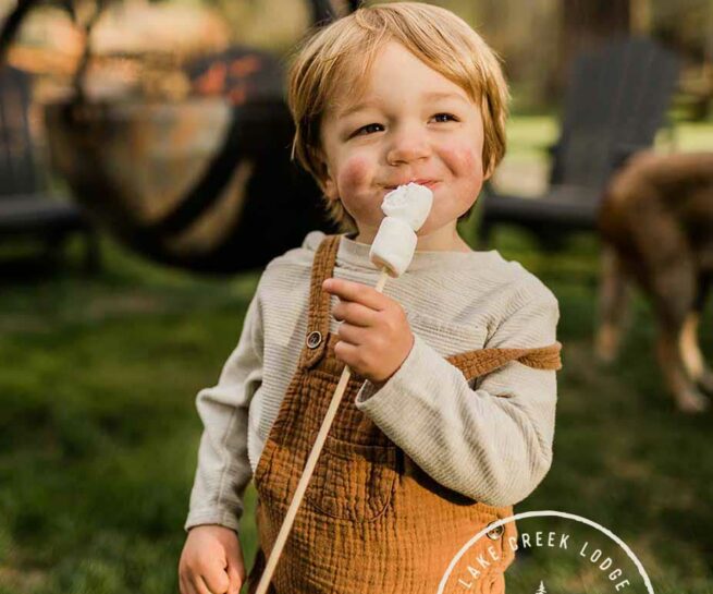 Happy child eating a marshmallow