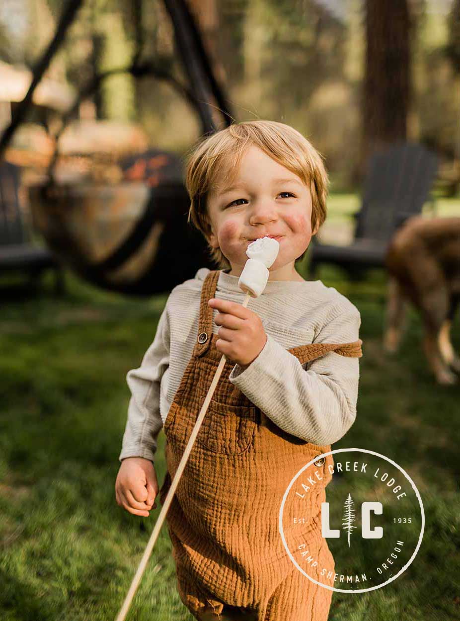 Happy child eating a marshmallow