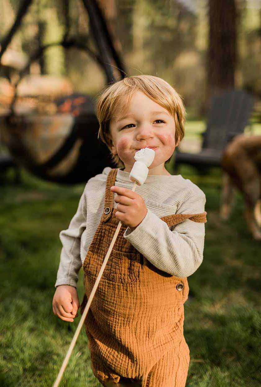 Happy child eating a toasted marshmallow