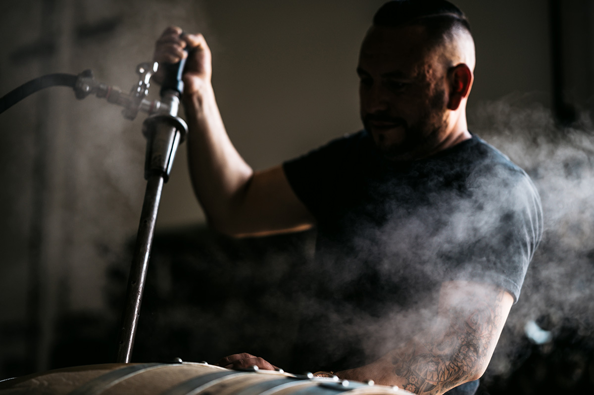 man cleaning barrels