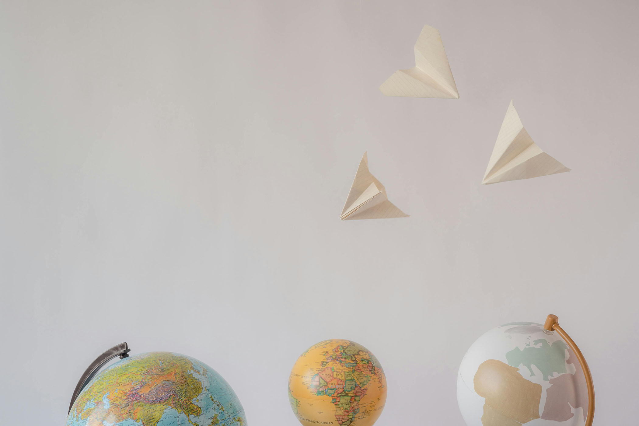 Paper airplanes and world globes
