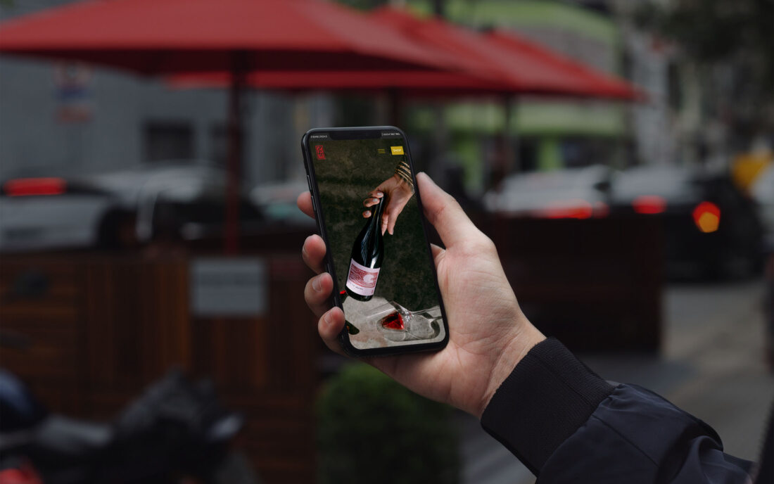 hand holding an iphone with winery website
