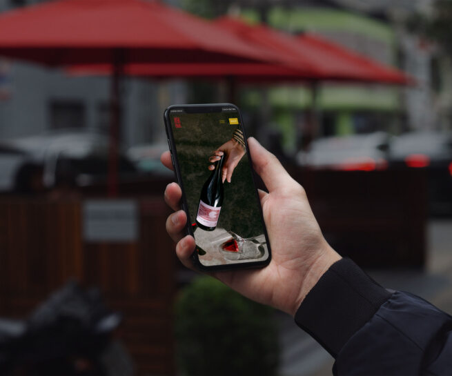 hand holding an iphone with winery website