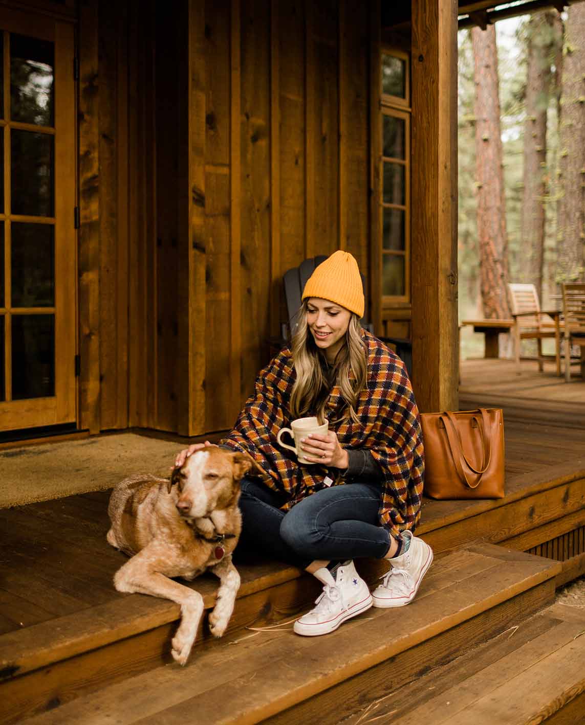 woman and dog outside cabin